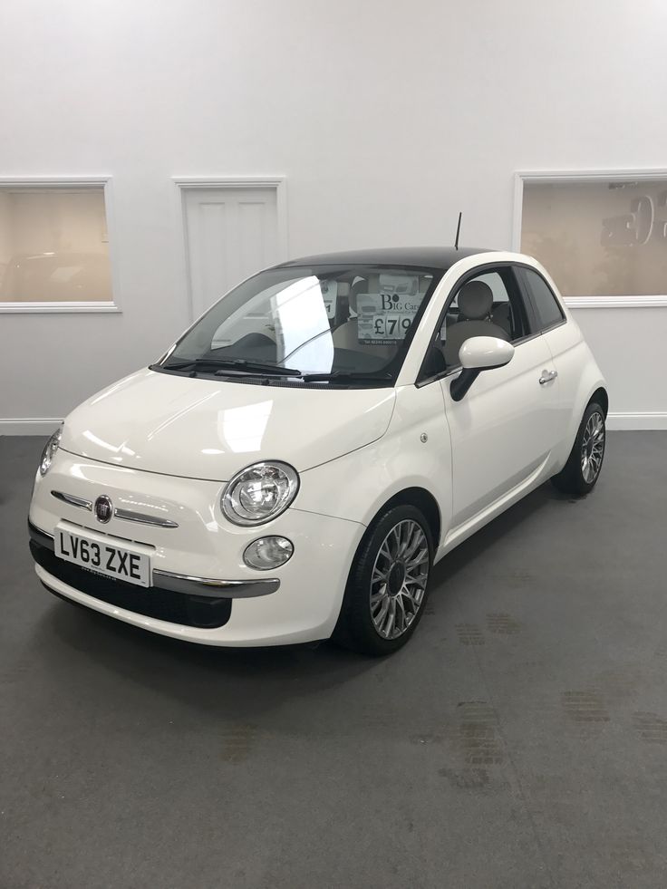 a small white car parked in a garage