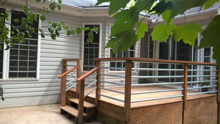 a wooden deck in front of a white house