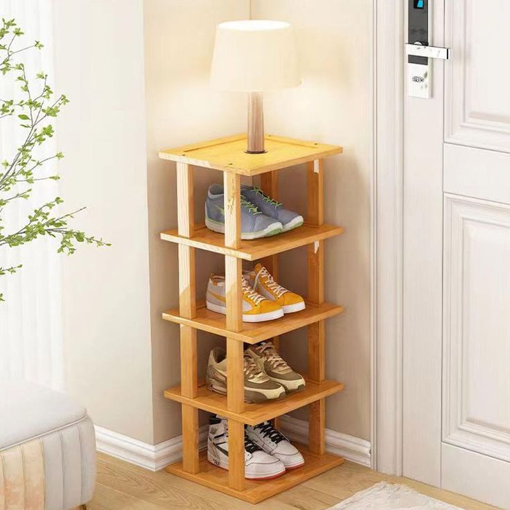 a wooden shelf with several pairs of shoes on it in front of a white door