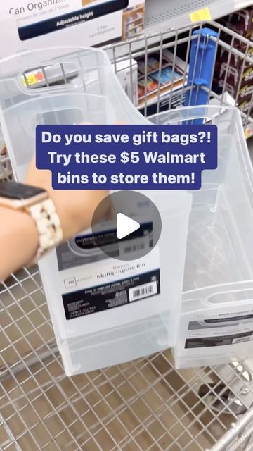 a person holding a cell phone in a shopping cart with the text do you save gift bags? try these $ 5 walmart bins to store them