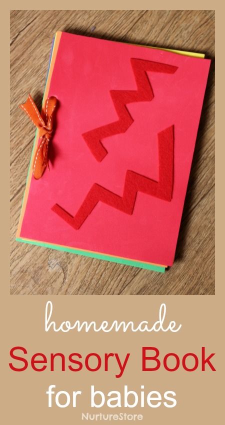 a pink notebook with red paper cut out of it and a bow on the side