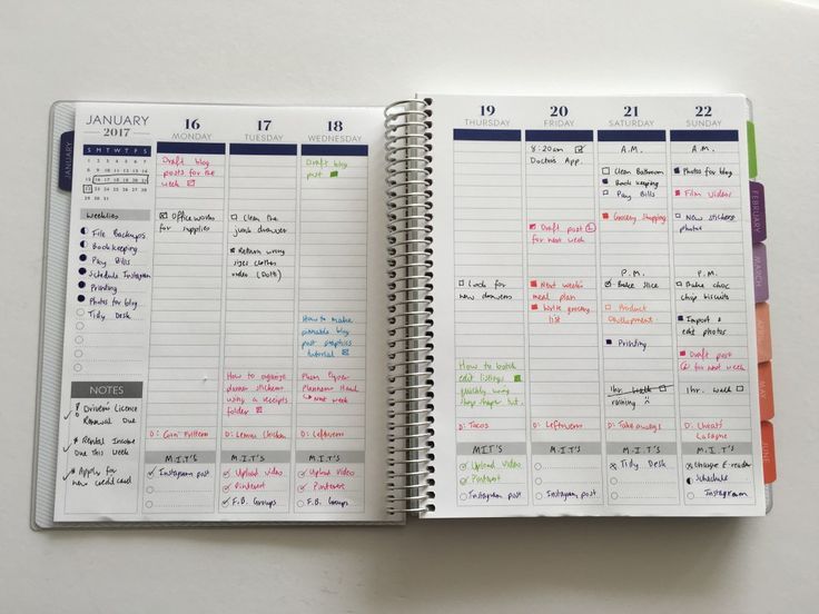 an open planner book with notes on the page and colored markers in it, sitting on top of a white surface