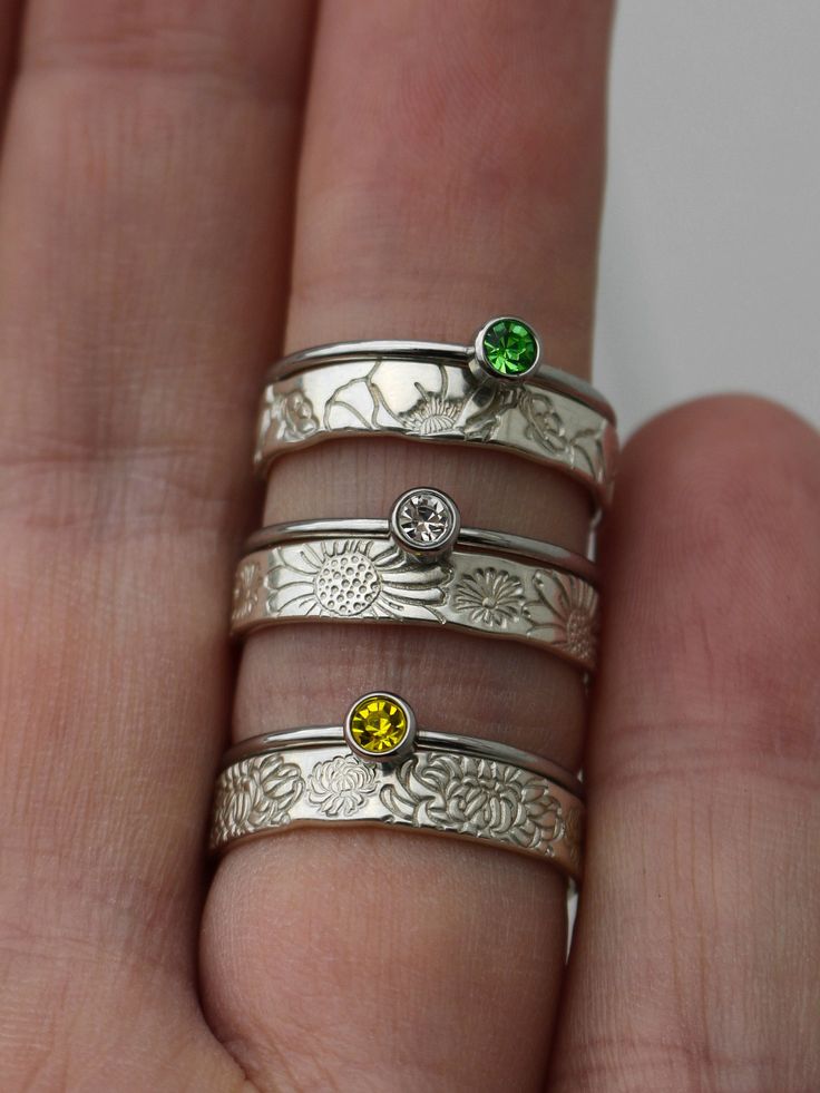 "Copy and paste into your browser, get 15% off ➔ https://bit.ly/VD15OFF This set is the perfect ring stack featuring both your birthstone and your birth flower. Choose from any of the 12 months and receive two rings that represent you or your loved one. DETAILS: -Two Rings Birthstone Ring: -Stainless Steel -1mm Band -3mm Cubic Zirconia stones Birth Flower Ring: -Sterling Silver -4mm Band You will receive one birthstone ring and one birth flower ring. **Every item is handmade, this means that eac Rings Birthstone, Birthstone Stacking Rings, Mother Rings, 2 Rings, Stacking Ring Set, Ring Stack, Birth Flower, Birth Flowers, Flower Ring