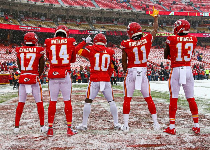 several football players are standing in the snow