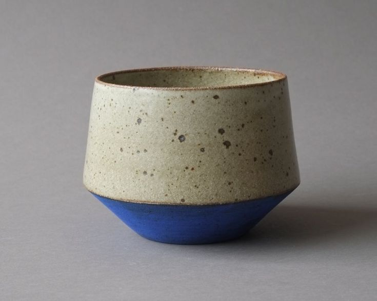 a blue and white cup sitting on top of a table