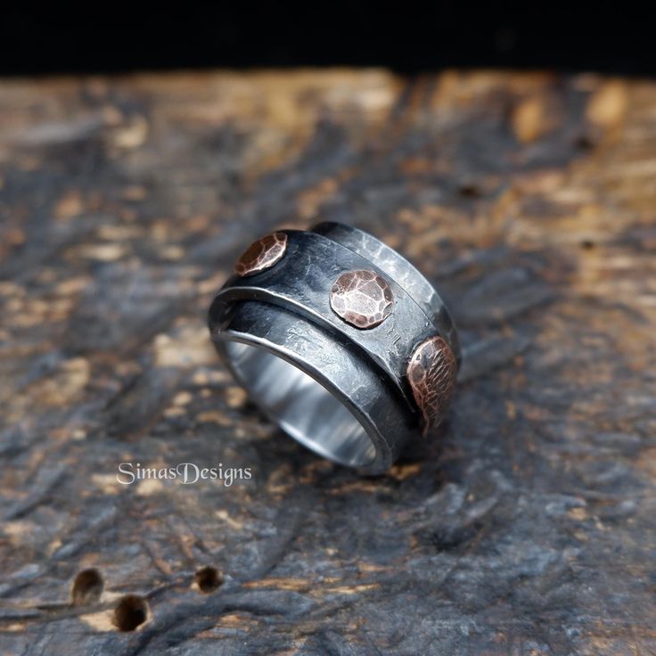 Hand crafted wide, hammered, rustic ring from stainless steel and copper rivets. Using traditional blacksmithing techniques of fire, hammer and anvil. Surface texture is achieved through different shaped hammers and hand held chisels and profiling tools. Width - up to 16.7 mm US size - 9 1/2 I recommend ordering wide rings slightly larger (up to 1/2 size), because they fit much tighter than a narrow ring of the same size. No two rings are ever a like. Presented in a gift bag. European & Internat Mixed Metal Ring, Rustic Ring, Wide Rings, Metal Ring, Ring Unique, Hand Forged, Rivets, Copper, Stainless Steel