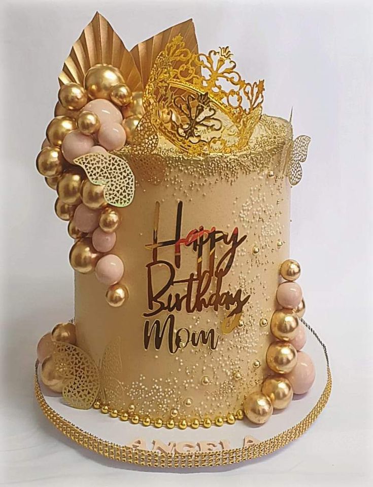 a birthday cake decorated with gold and pink decorations