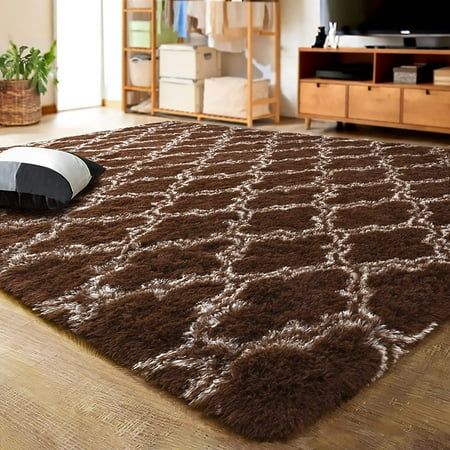 a living room with a brown rug on the floor