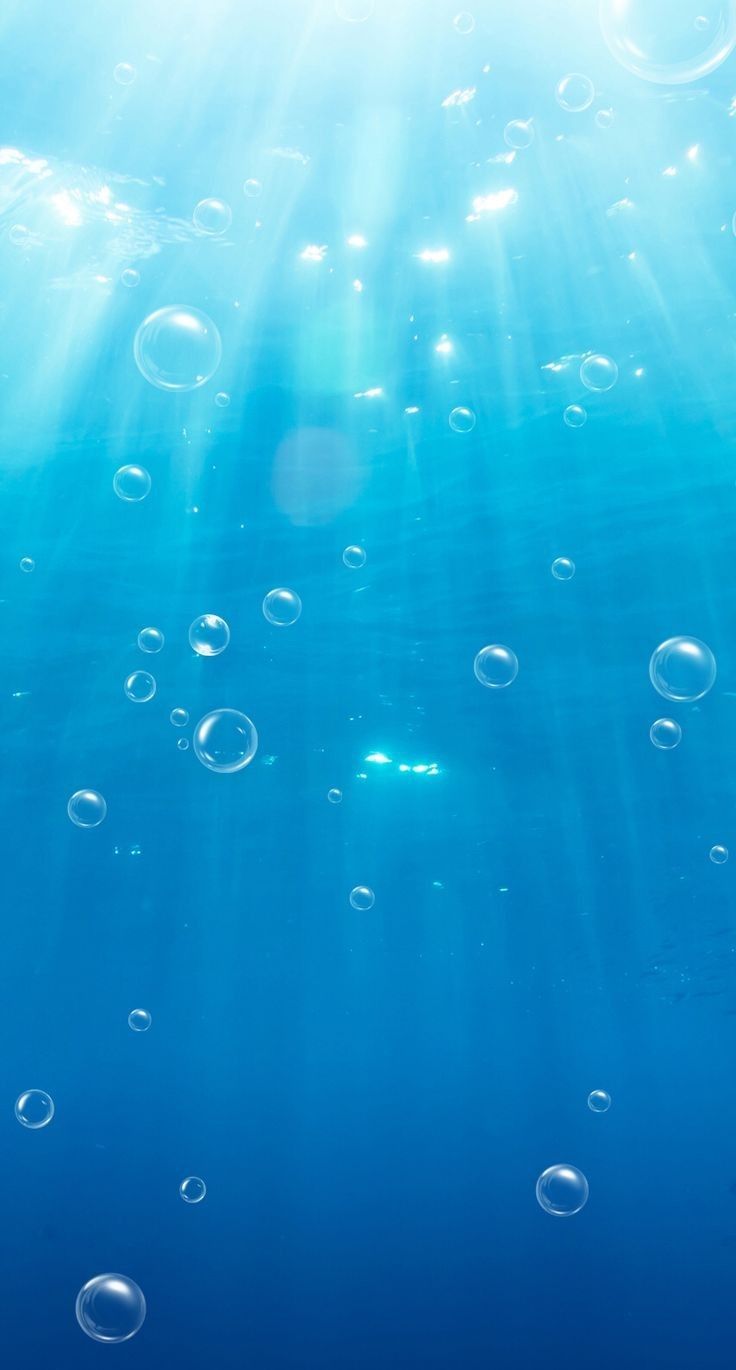 bubbles floating in the blue water with sunbeams