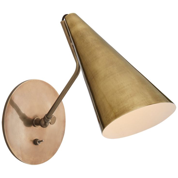 a wall light with a gold shade on it