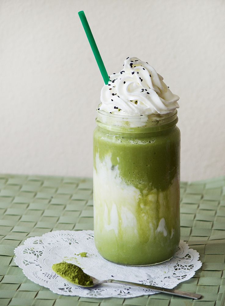 a green smoothie with whipped cream and sprinkles