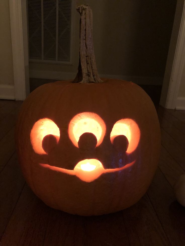 a carved pumpkin with glowing eyes on it