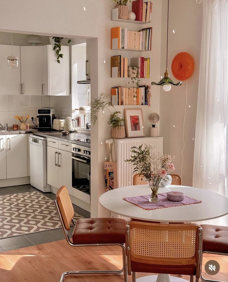 a kitchen with a table and chairs near a stove top oven in the middle of it