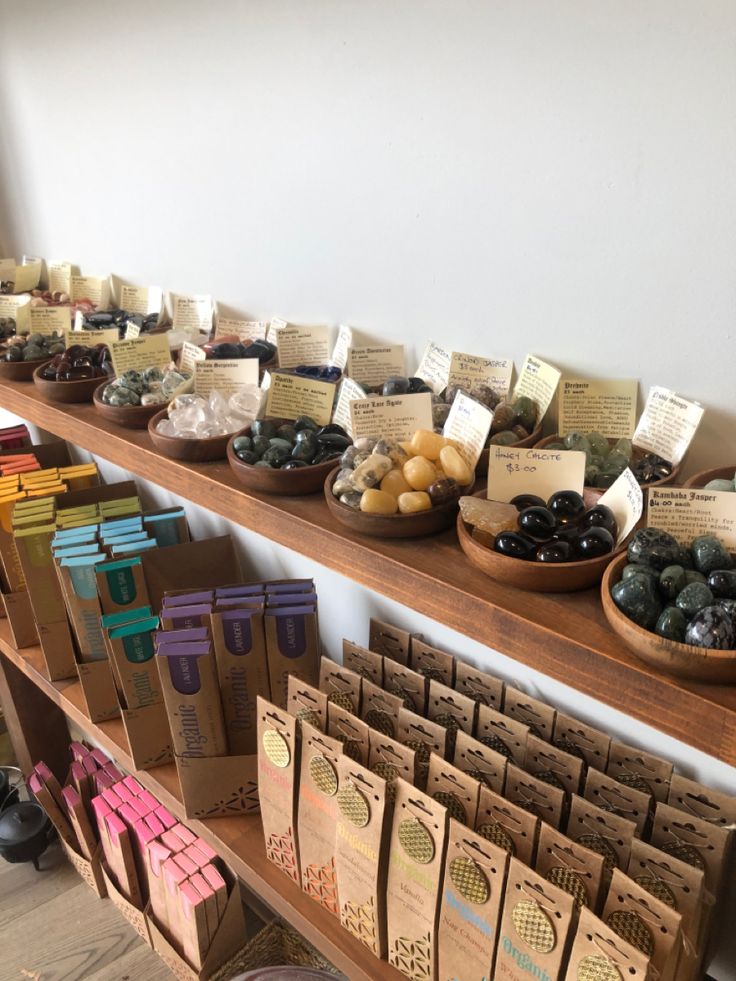 there are many boxes and bags on the shelves in this store that is filled with different types of fruit