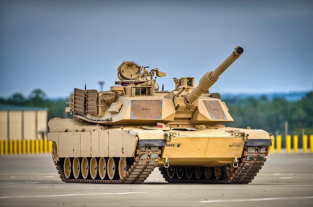 an old tank sitting on top of a parking lot