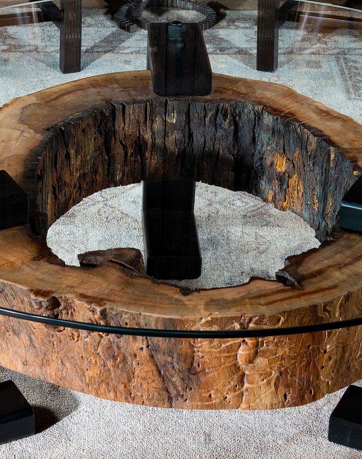 a table made out of wood and glass with a black object on it's top