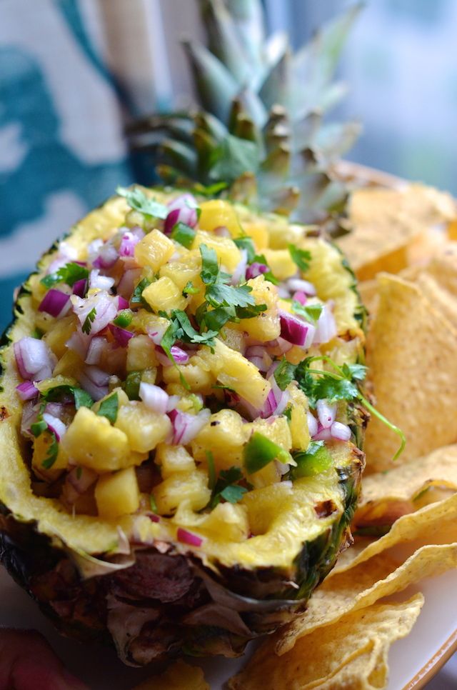 a pineapple and onion salad on a roll with tortilla chips