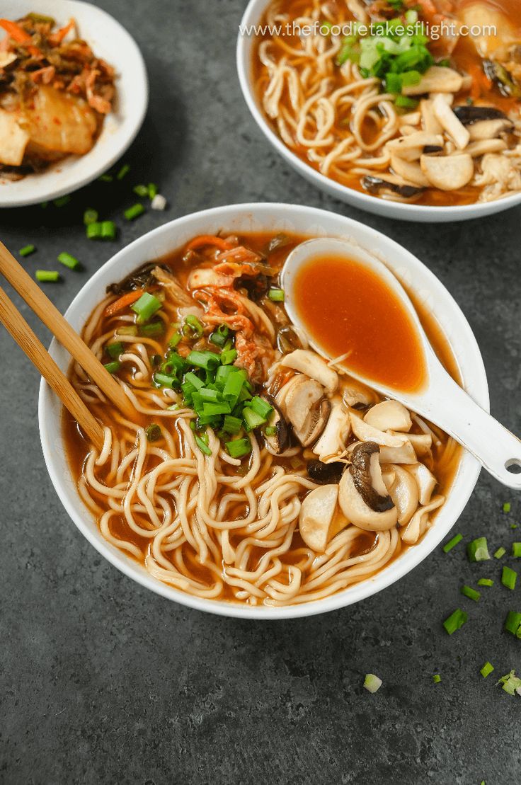 two bowls of soup with chopsticks on the side