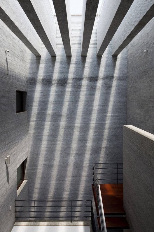 the interior of a building with concrete walls and stairs