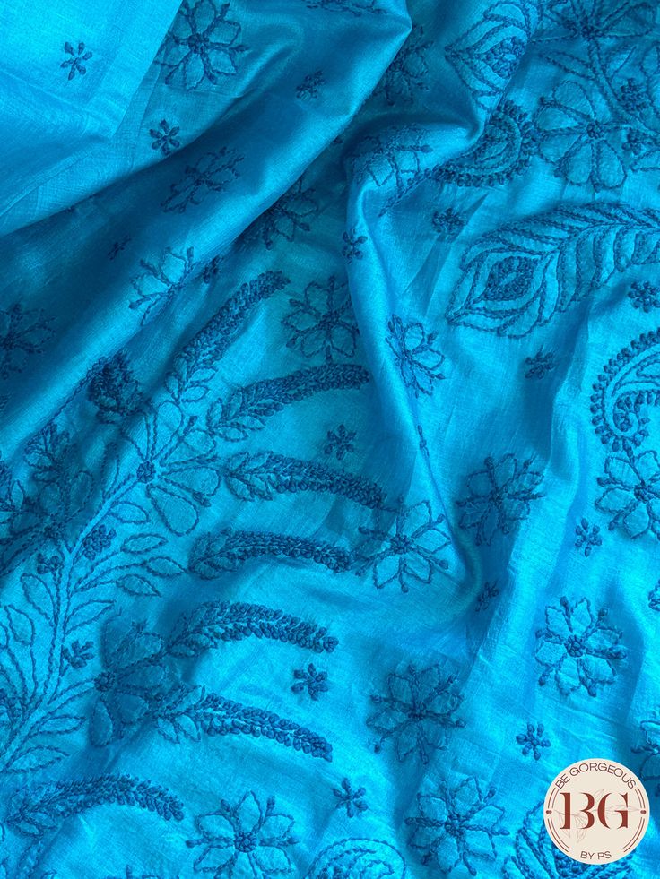 This exquisite blue silk piece showcases intricate Chikankari embroidery, a handcrafted technique that dates back to the Mughal era. Designed to elevate any outfit, this one-of-a-kind piece exudes timeless elegance and luxury. Experience the art of Chikankari and indulge in the finest craftsmanship with this stunning silk creation. Chikankari on Silk - Blue Saree comes with a blouse piece. Fall and pico done. Fully stitched blouse shown in pictures is optional and can be purchased seperately from our blouses and croptops section. For saree video please connect with us on whatsapp @469-937-0606 Ready to be shipped in USA from San Diego, California. All pictures are original pictures. Colors may slightly vary due to pic resolution. Blue Slub Silk Traditional Bollywood Wear, Festive Blue Slub Silk Traditional Wear, Blue Slub Silk Traditional Wear For Festive Occasions, Designer Blue Slub Silk Dupatta, Blue Festive Slub Silk Traditional Wear, Elegant Blue Slub Silk Dupatta, Unstitched Light Blue Traditional Wear With Resham Embroidery, Blue Unstitched Ceremonial Traditional Wear, Diwali Light Blue Traditional Wear With Chikankari Embroidery