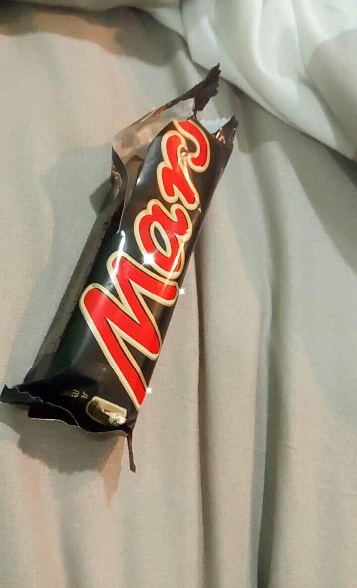 a bar of chocolate sitting on top of a bed