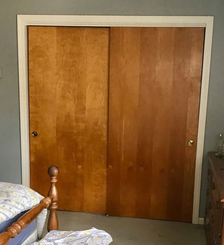 a bedroom with a bed and two wooden doors