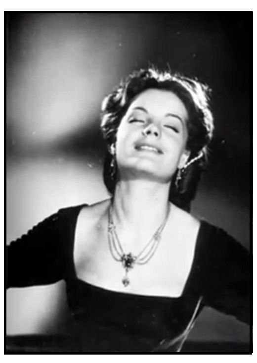 an old black and white photo of a woman with her eyes closed, wearing a necklace