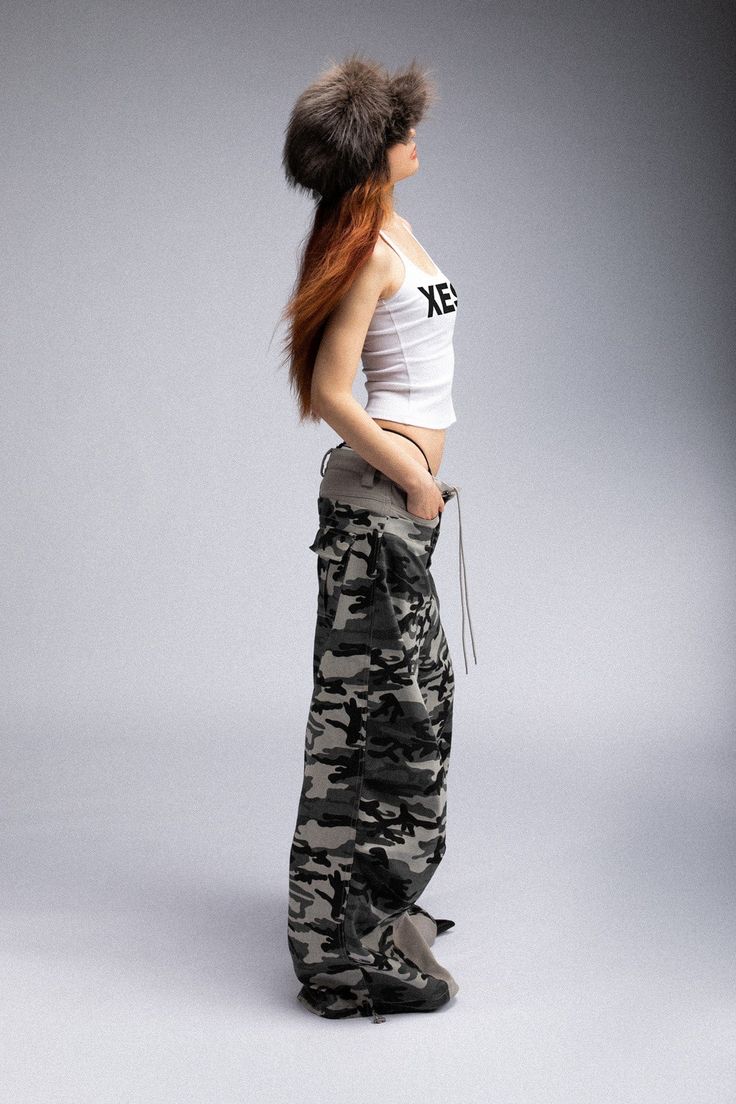 Description: The Double-Waist Spliced Camo Wide-Leg Pants seamlessly blend casual street vibes with sophisticated craftsmanship. Featuring a bold spliced design, these pants consist of a light gray inner crotch with camo on the outside, creating a unique, standout look. Both the front and back feature dual pockets, providing ample storage space. The adjustable drawstring waist and adjustable leg openings offer a customizable fit, ensuring comfort and versatility. Made from premium fabric, these Camuflage Outfit Pants, Street Vibes, Camo Fabric, Adjustable Legs, Grunge Y2k, Brand Sale, Layers Design, Accessories Branding, Pants Outfit