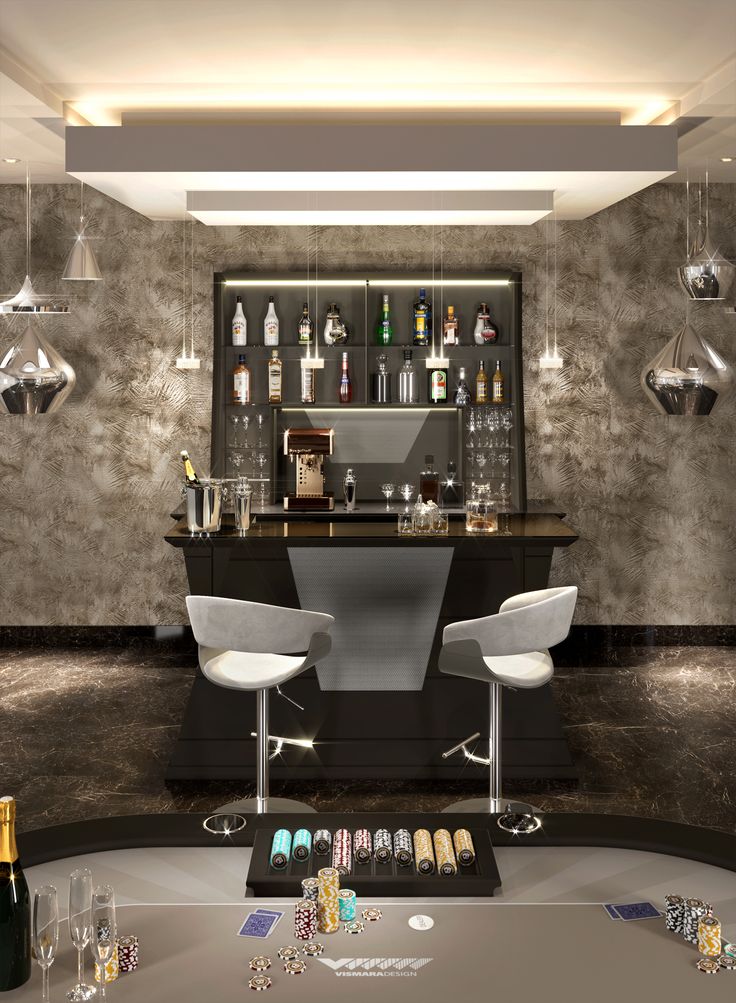 a room with two chairs and a bar in the back ground, filled with liquor bottles