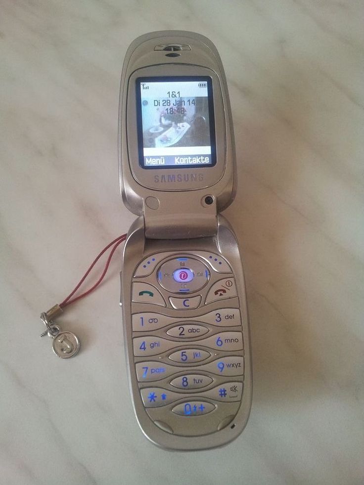 an old cell phone sitting on top of a table