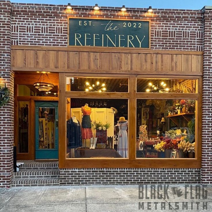 the storefront of a clothing store with mannequins on display