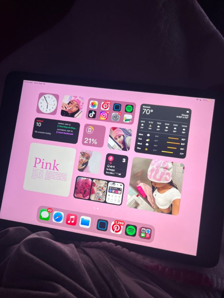 a pink tablet with pictures on the screen