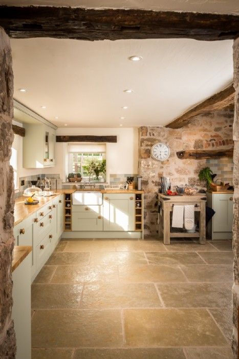 an open kitchen with stone walls and flooring