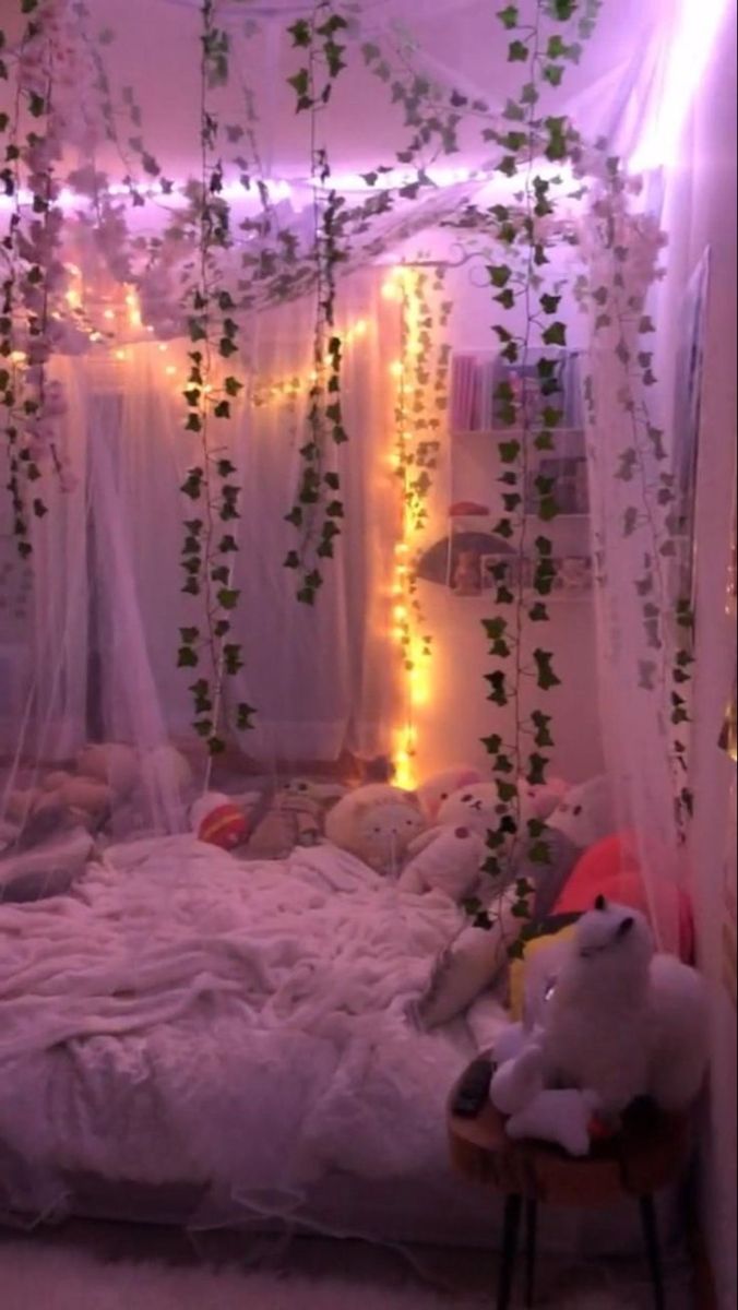 a bedroom decorated with vines and lights