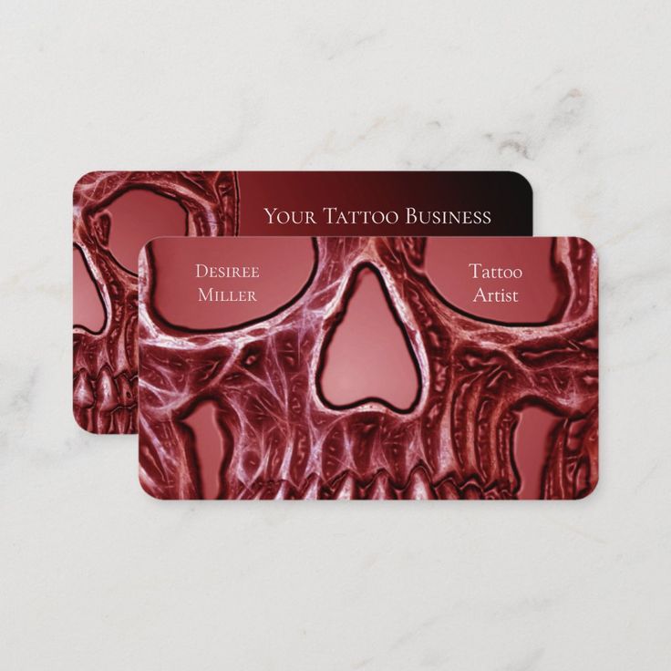 two business cards with the words your tattoo business written on them and an image of a human skull