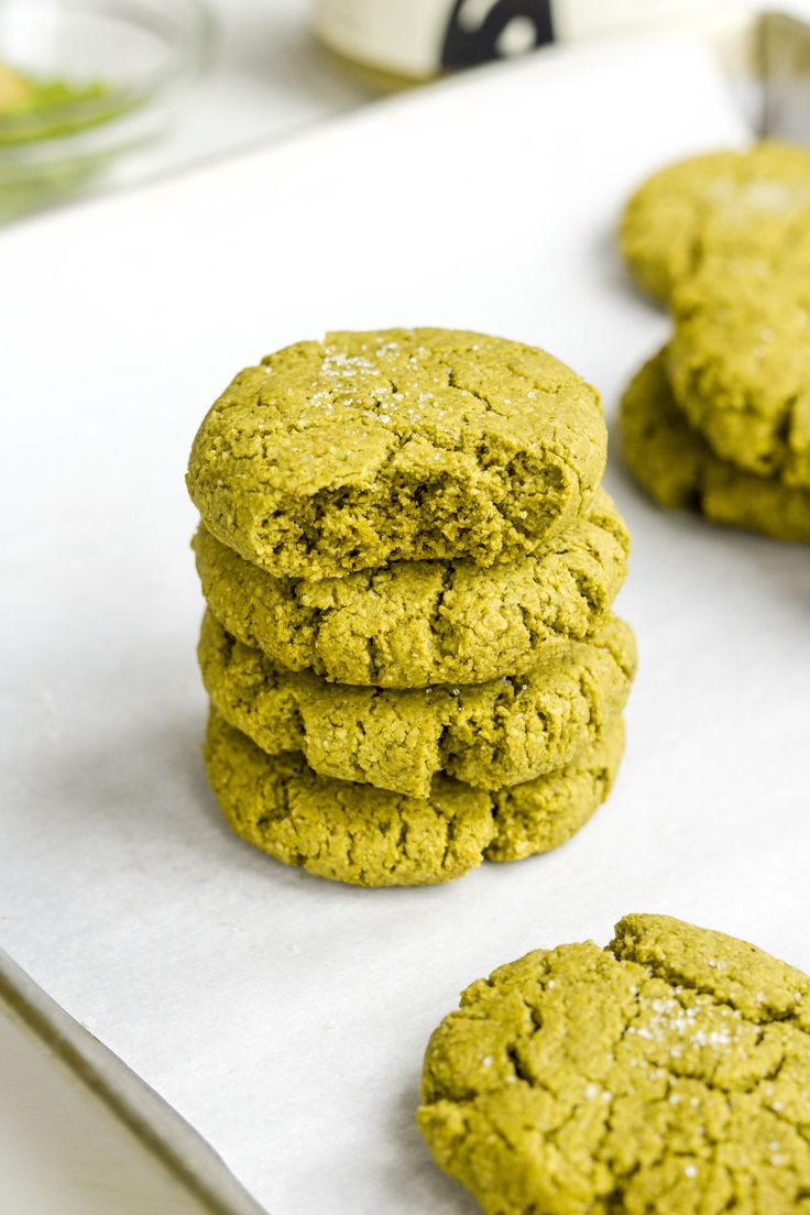 green cookies are stacked on top of each other and ready to be baked in the oven