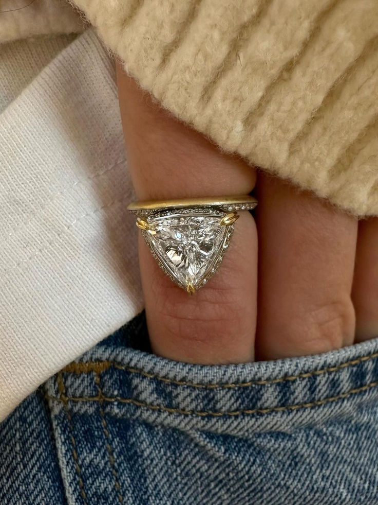 a woman's hand with a diamond ring on it