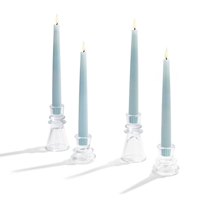 three candles are lined up next to each other with one candle in the middle and two on the side