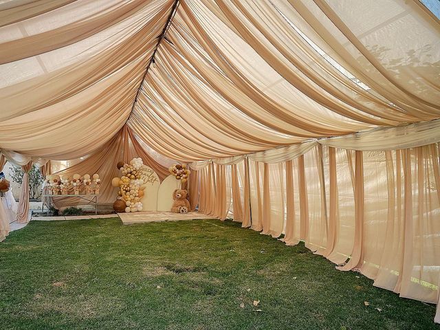 the inside of a wedding tent is decorated with flowers and teddy bears on it's side