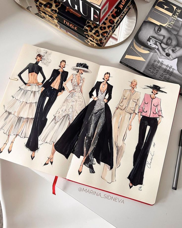 an open book with fashion illustrations on it next to a pen and pencil drawing machine