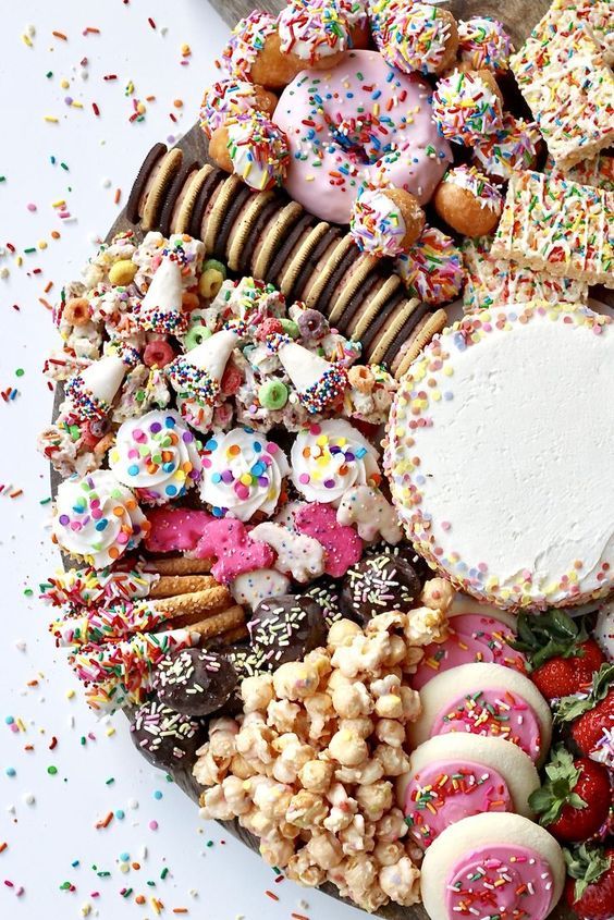 a platter filled with lots of different types of donuts and other desserts