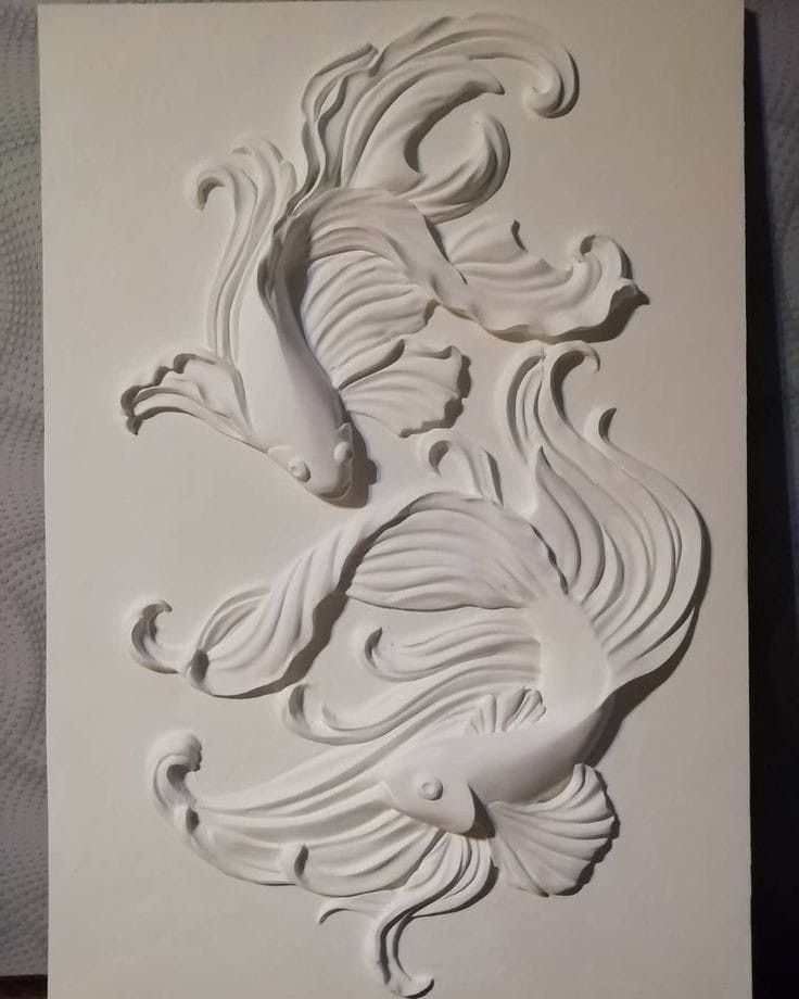 an intricately carved white paper with two birds on it