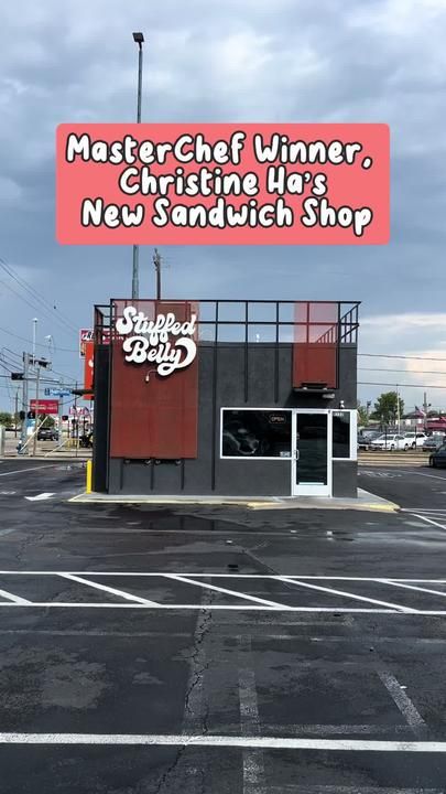 an empty parking lot with a sign that says master chef winner, christine has new sandwich shop