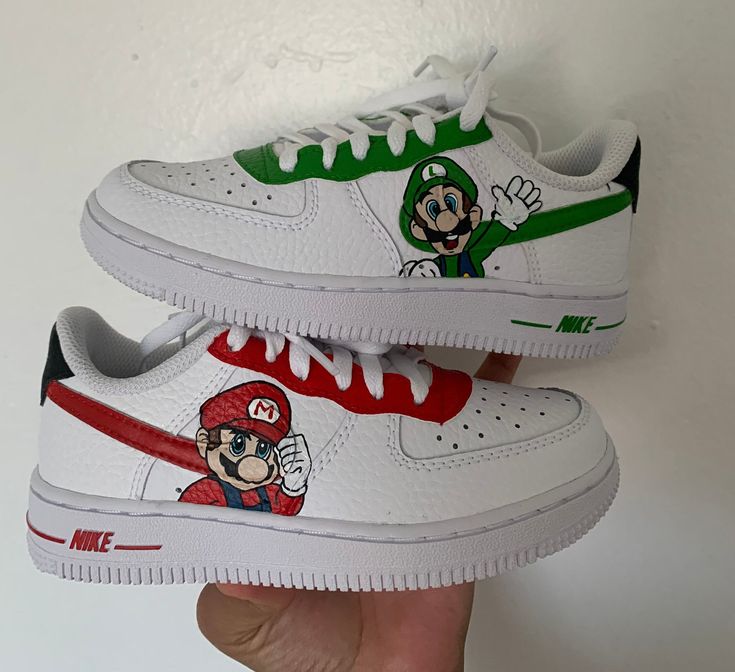 Mario and Luigi Super Mario Bros Custom Air Force shoes, painted with the highest quality shoe paint. The paint will not scratch or chip off easily. Please feel free to message me for any changes you want made to the shoes. To check out my other designs check out my IG: fortheart_LZ MESSAGE ME FOR DISCOUNT! Mario Painted Shoes, Costom Shoes, Mario Shoes, Baby Jordan Shoes, Mario Und Luigi, Custom Sneakers Diy, Nike Air Force 1 Custom, Air Force Shoes, Custom Painted Shoes