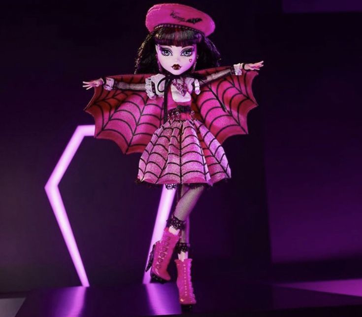 a doll is dressed in pink and purple