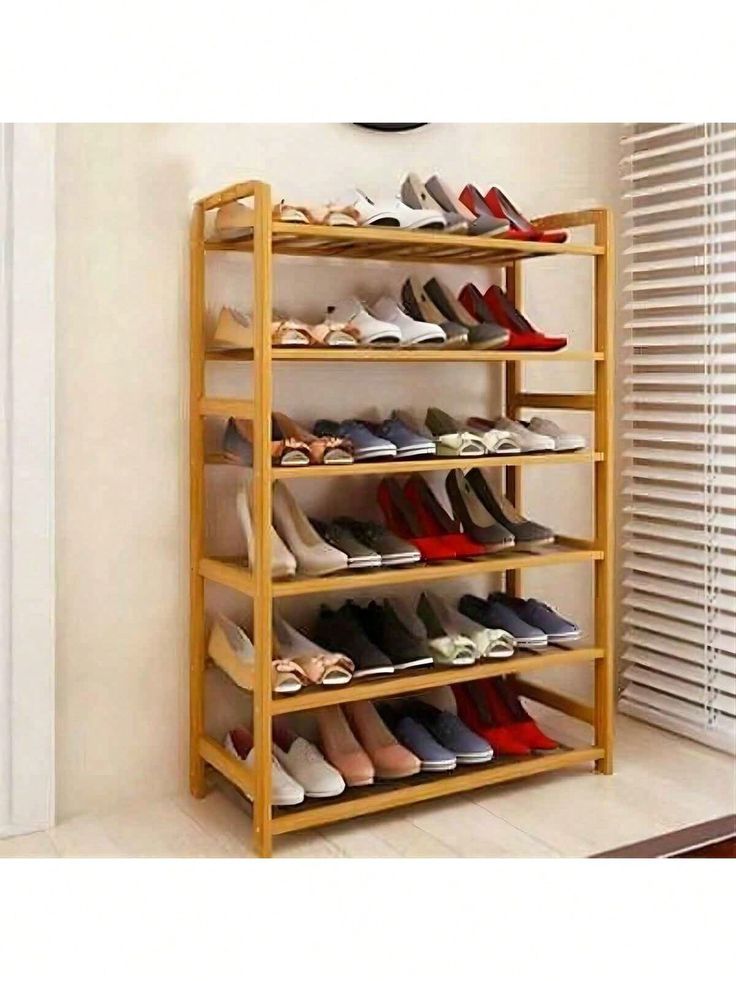 a wooden shoe rack filled with lots of shoes