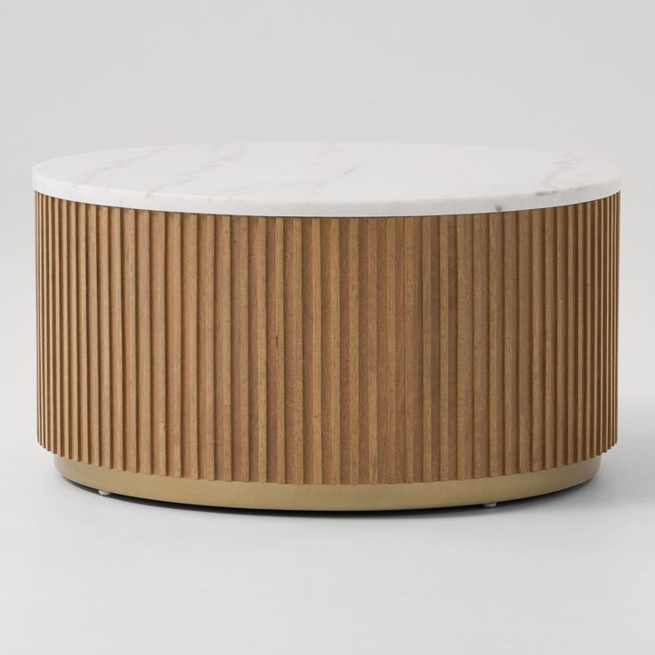 a round wooden table with white marble top