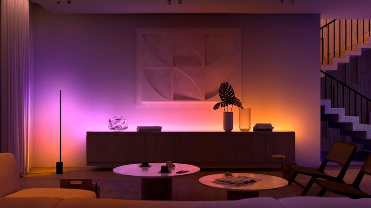 the living room is lit up with purple lighting and modern furniture, including a coffee table