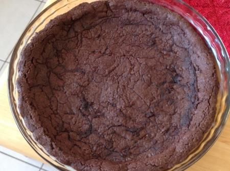 a chocolate pie sitting on top of a wooden table