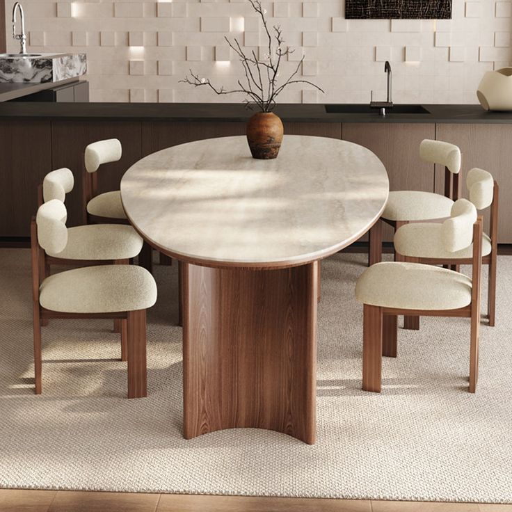 a dining room table with chairs and a vase on the center piece, in front of a kitchen counter